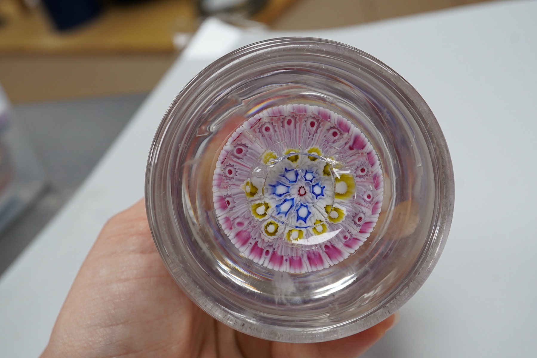 Two millefiori glass paperweights and an inkwell, 12cm high